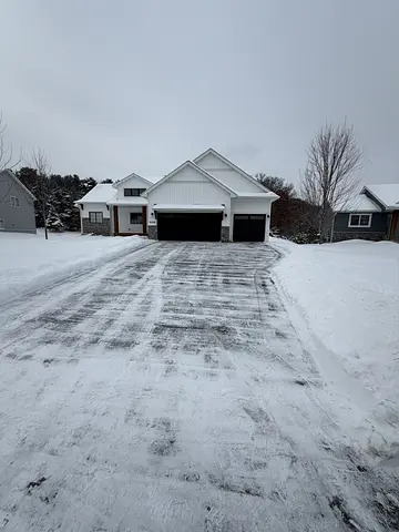Cleared driveway with light snow remaining at a Winnipeg home